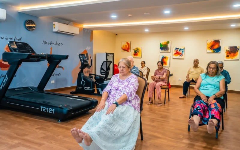 Seniors at a seated exercise class in the Jagriti Dham gymnasium