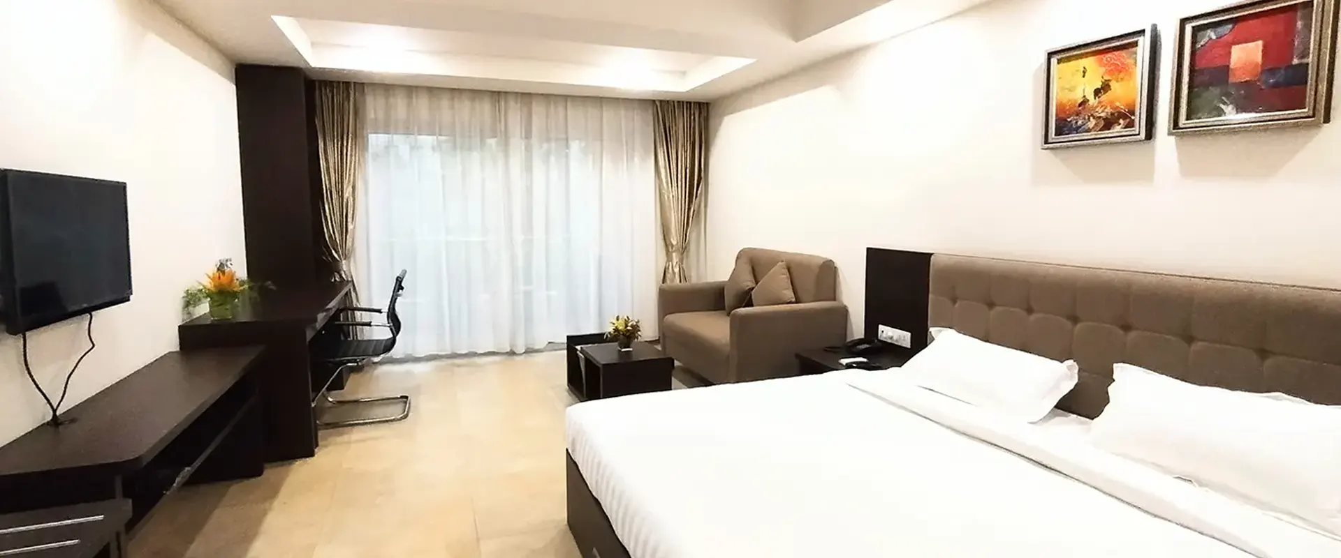 A fully furnished air-conditioned room with an attached balcony