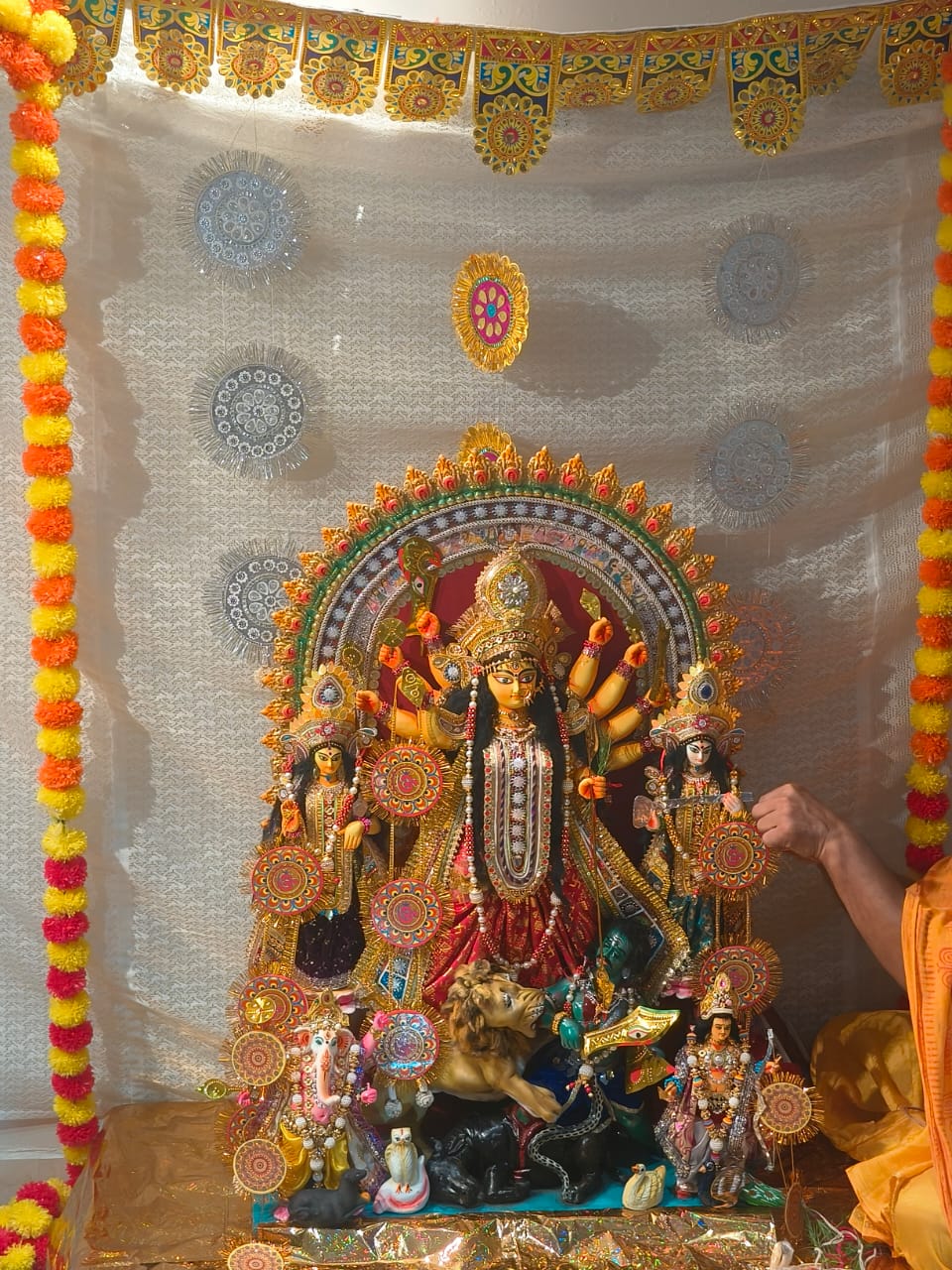 The beautifully decorated Durga idol (pratima) worshipped at Jagriti Dham, showing the goddess with her children Lakshmi, Saraswati, Kartik, and Ganesh.