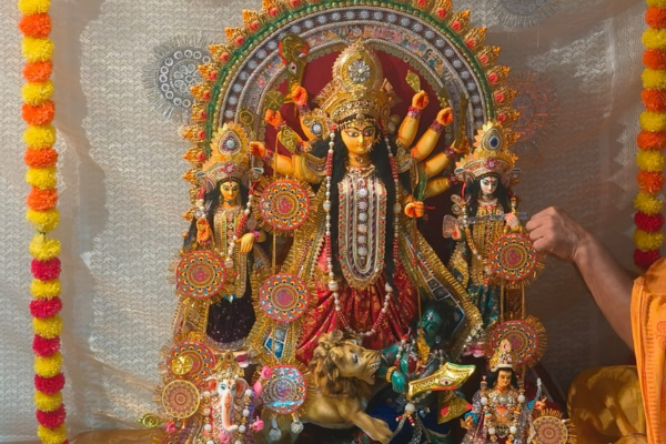The beautifully decorated Durga idol (pratima) worshipped at Jagriti Dham, showing the goddess with her children Lakshmi, Saraswati, Kartik, and Ganesh.