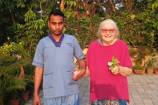 Senior residents enjoying a peaceful morning walk amidst the lush green gardens of Jagriti Dham, a luxurious old age home in Kolkata.