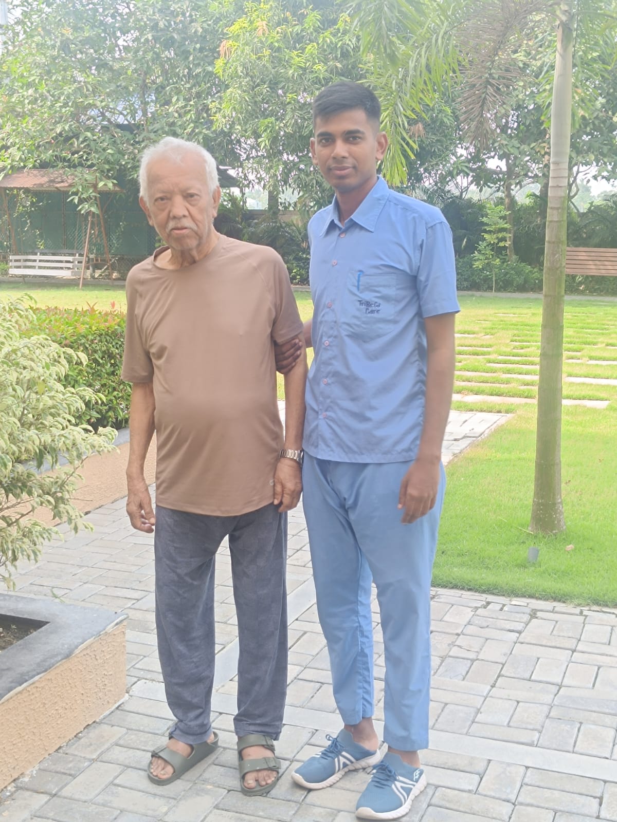 Senior residents enjoying a peaceful morning walk amidst the lush green gardens of Jagriti Dham, a luxurious old age home in Kolkata.