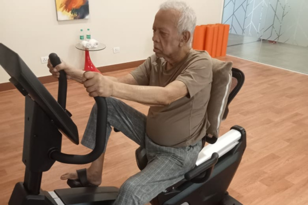 Senior residents engaging in cognitive wellness activities and writing exercises together at Jagriti Dham, a premium old age home in Kolkata.