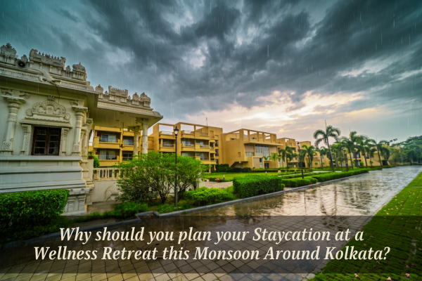 Scenic view of a serene wellness retreat around Kolkata featuring a traditional temple structure, modern residential suites, and wet-paved pathways during monsoon rain.