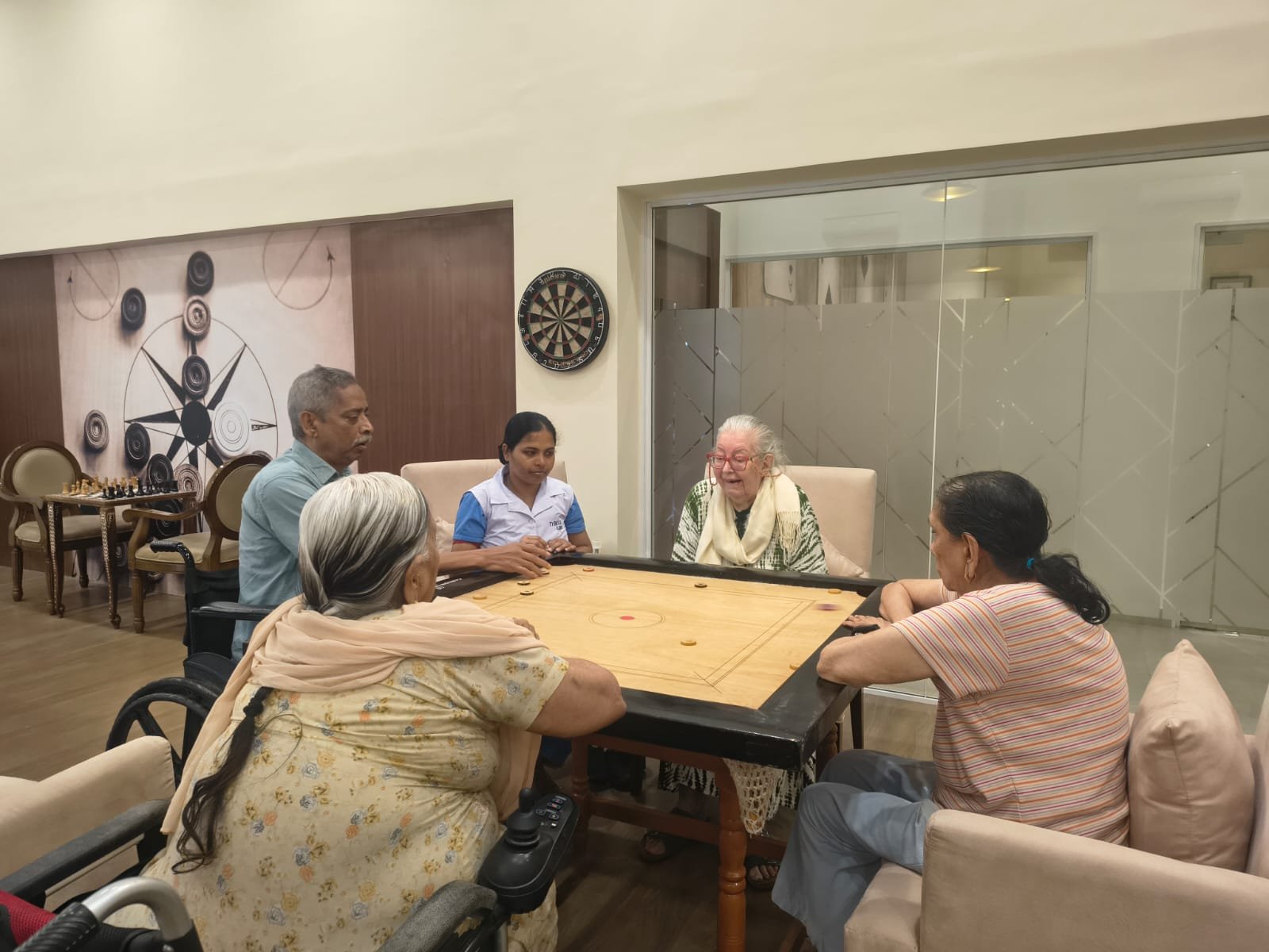 Seniors playing indoor games in luxury senior living facilities.