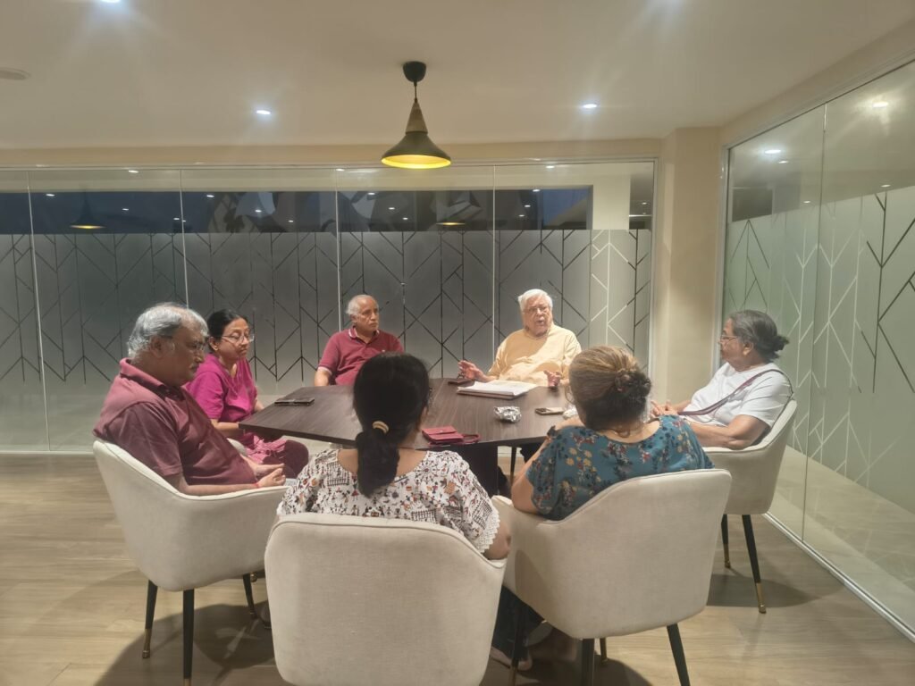 Seniors having a group discussion in luxury senior living facilities.