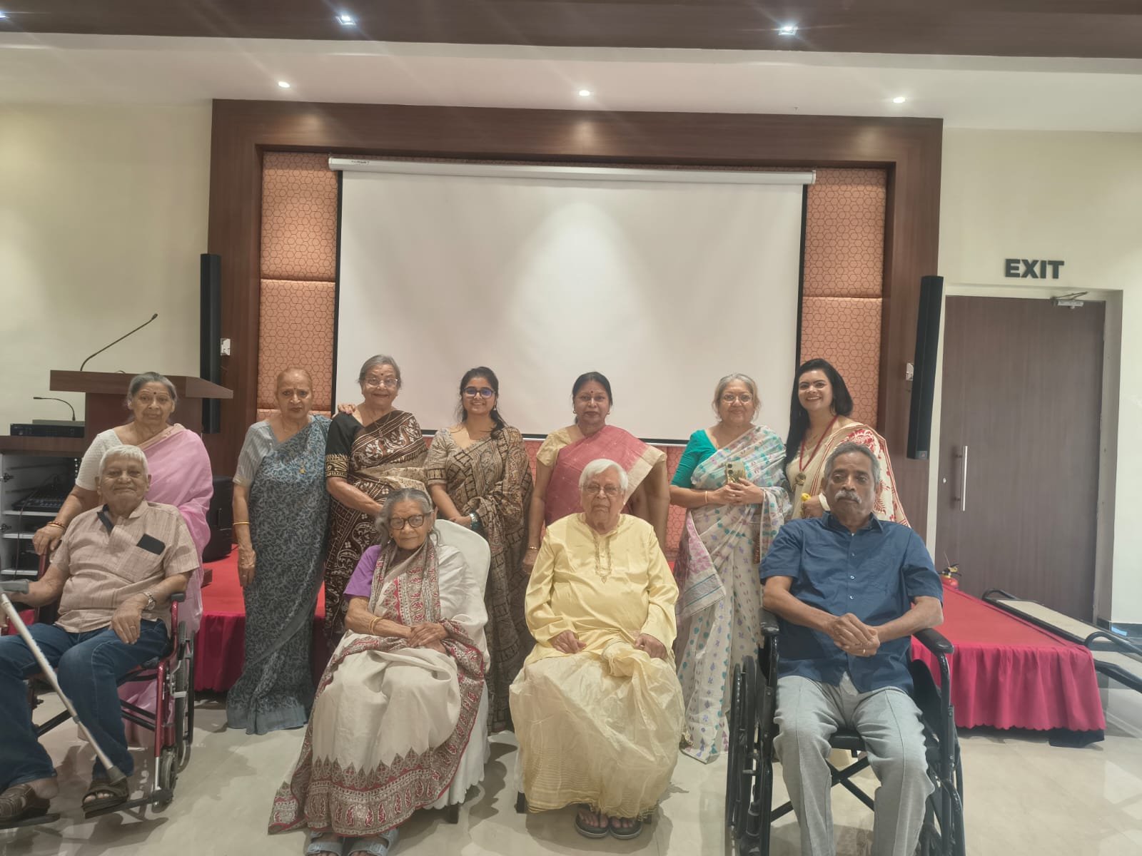 Senior living communities bringing elderly residents and caregivers together for a group photo at a community event.
