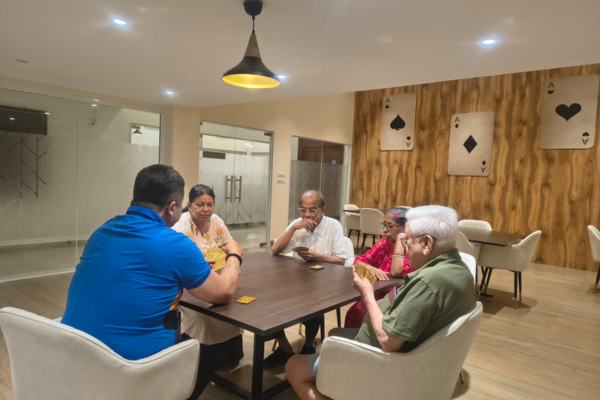 Seniors playing cards at Jagriti Dham